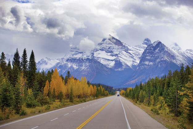 snowy mountain peaks above a country road