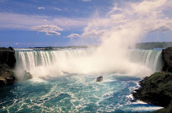 Niagara Falls in the daytime with blue skies and clouds