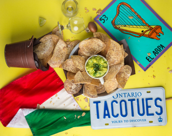 tortilla chips and dip next to a Mexican flag and an Ontario licence plate saying tacotues