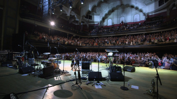 Massey Hall full of people with an empty stage