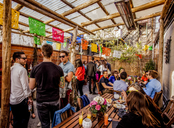 people enjoying the sunshine in an outdoor bar