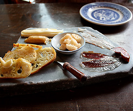 a tapas board on a stone platter