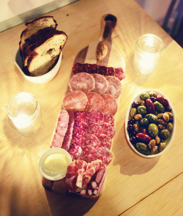 charcuterie board with olives and bread