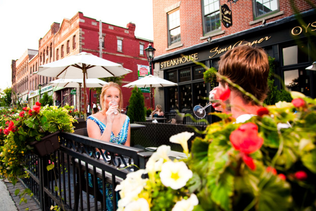 couple enjoy a drink together on the outdoor terrace of Sims