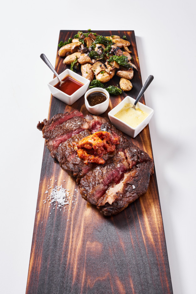 steak and potatoes on a wooden board