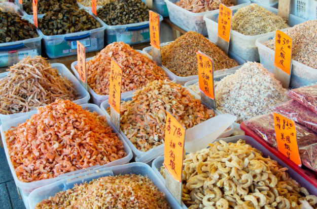 mounds of seafood in an outdoor food market
