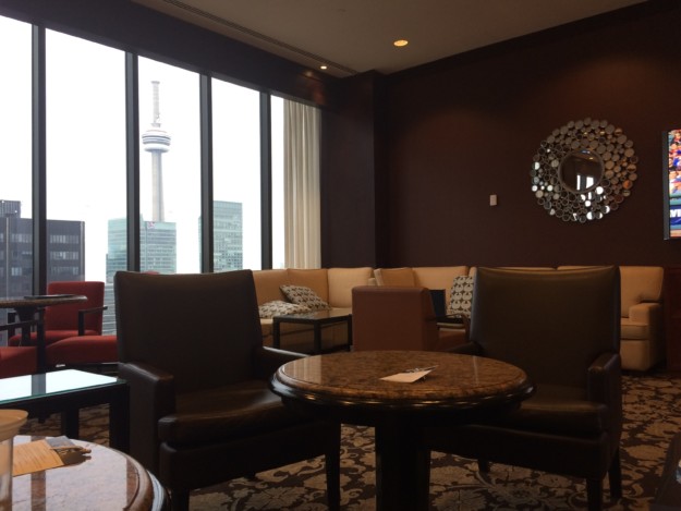 An image of a brown lounge with two chairs in the foreground