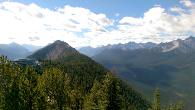 the gondola station at the top of the mountain looks out over the rolling valleys and mountain peaks