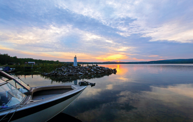 sunset behind a lighthouse on Manitoulin Island