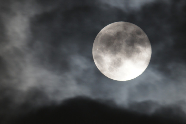 Super moon in cloudy sky