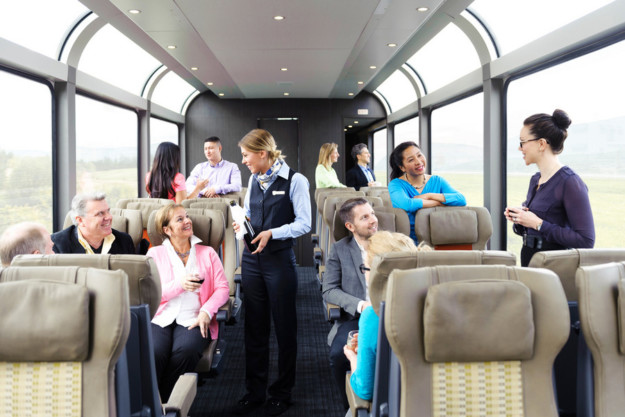 guests are served champagne in a luxury train carriage