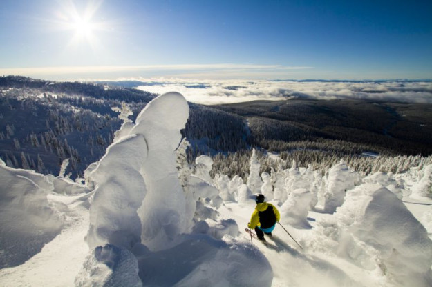 skier in yellow jacket overlook steep off piste section