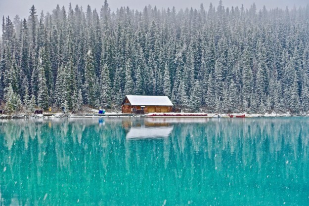 A winter image with a turquoise lake in the foreground