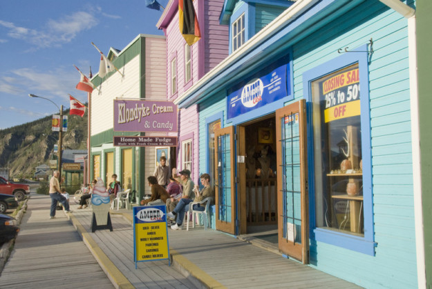 a sweetshop and other businesses situated in colourfully painted wooden buildings