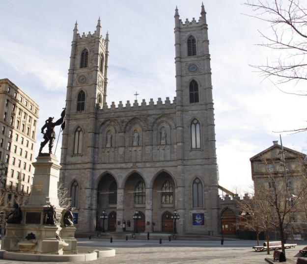 Notre-Dame Basilica exterior with statue in the foreground