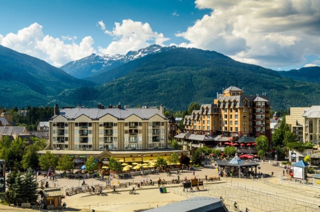 a town square in Whistler with mountains in the background