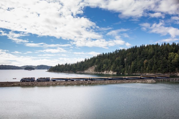 train travels along a narrow stone track surrounded by water