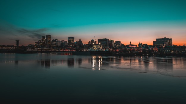 the sun sets behind the Montreal skyline
