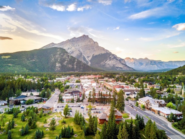 an aerial view of Banff in the summer with the mountain in the background