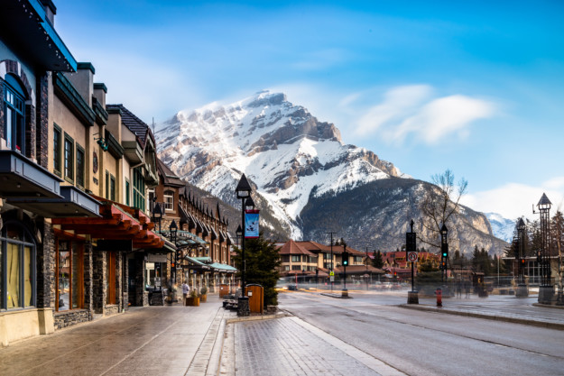a banff street with a snow-capped mountain in the background