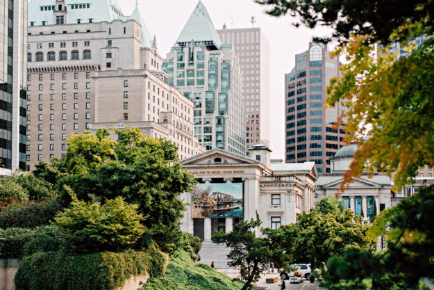 the exterior of Vancouver Art Gallery with green trees in the foreground