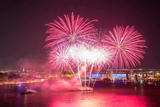 a firework display launching from a floating platform