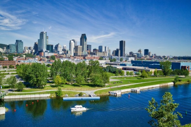 Montreal skyline in the background with a boat on the river in the foreground
