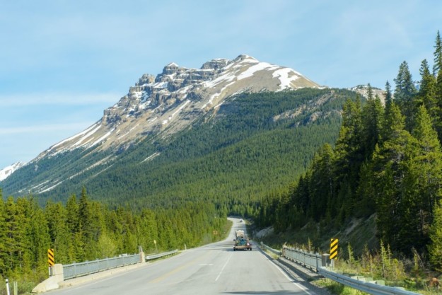 a mountain stands in front of a highway