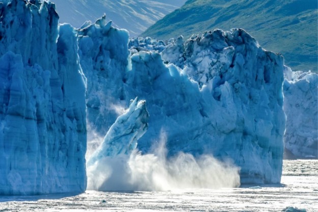 an ice shelf falling from a glacier into the water