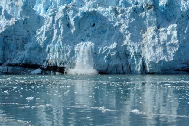 an ice shelf falling from a glacier into the water