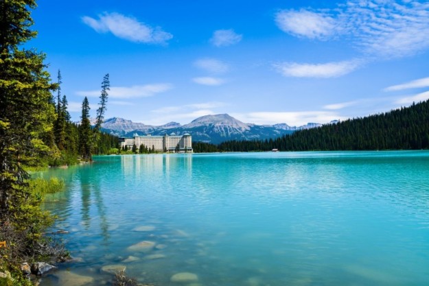 the turquoise waters of Lake Louise stretch out towards the Fairmont Chateau