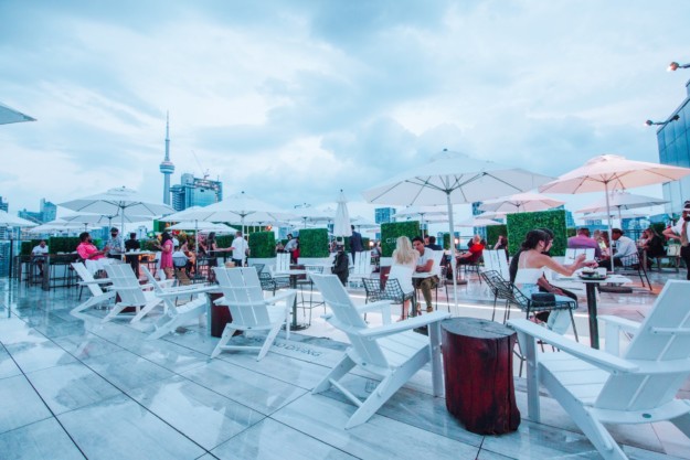 people sit at table rooftop dining