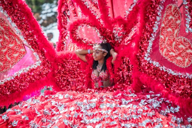 carnival performer in elaborate red and silver costume