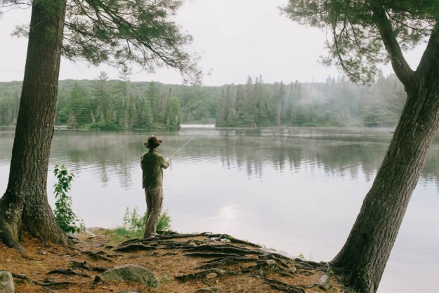 A man fishing at a lake in Canada