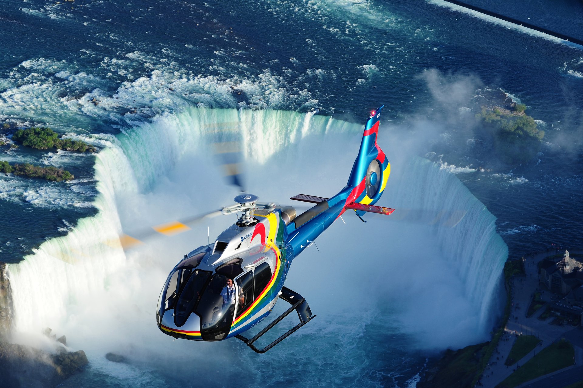 A helicopter flies over Niagara Falls
