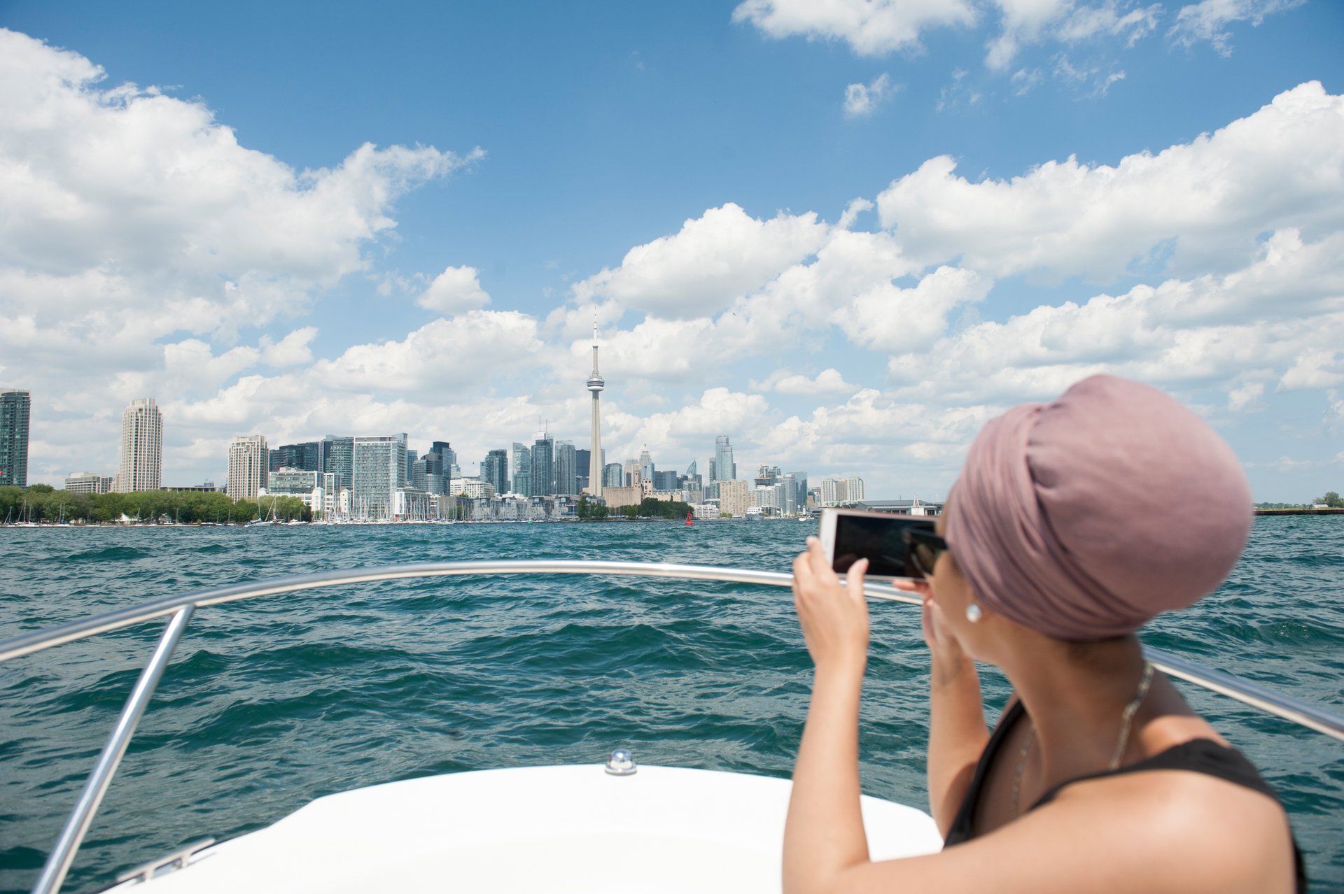 Man in canoe observes the Toronto skyline from Lake Ontario
