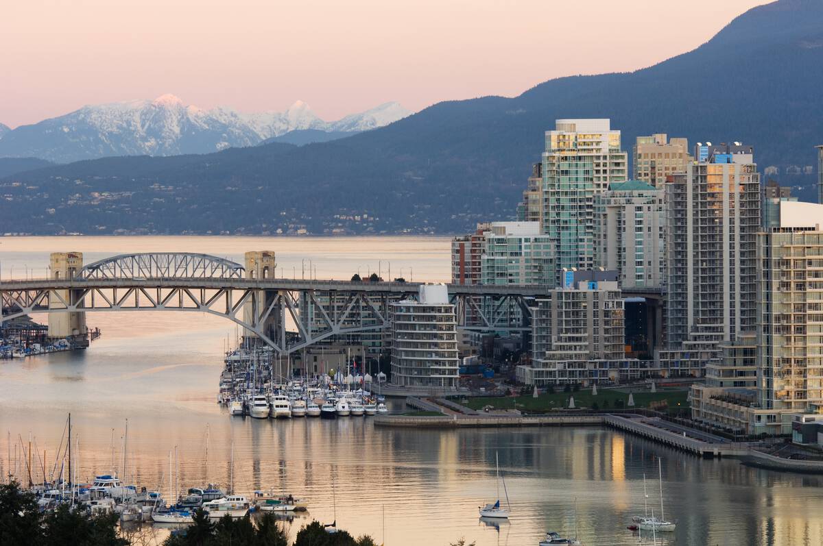 a bridge in Vancouver with snow-capped mountains in the background