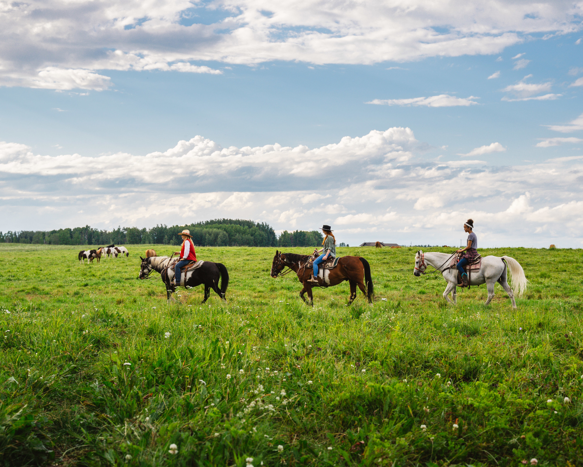 Visitors horseback riding in Head-Smashed-In Buffalo Jump
