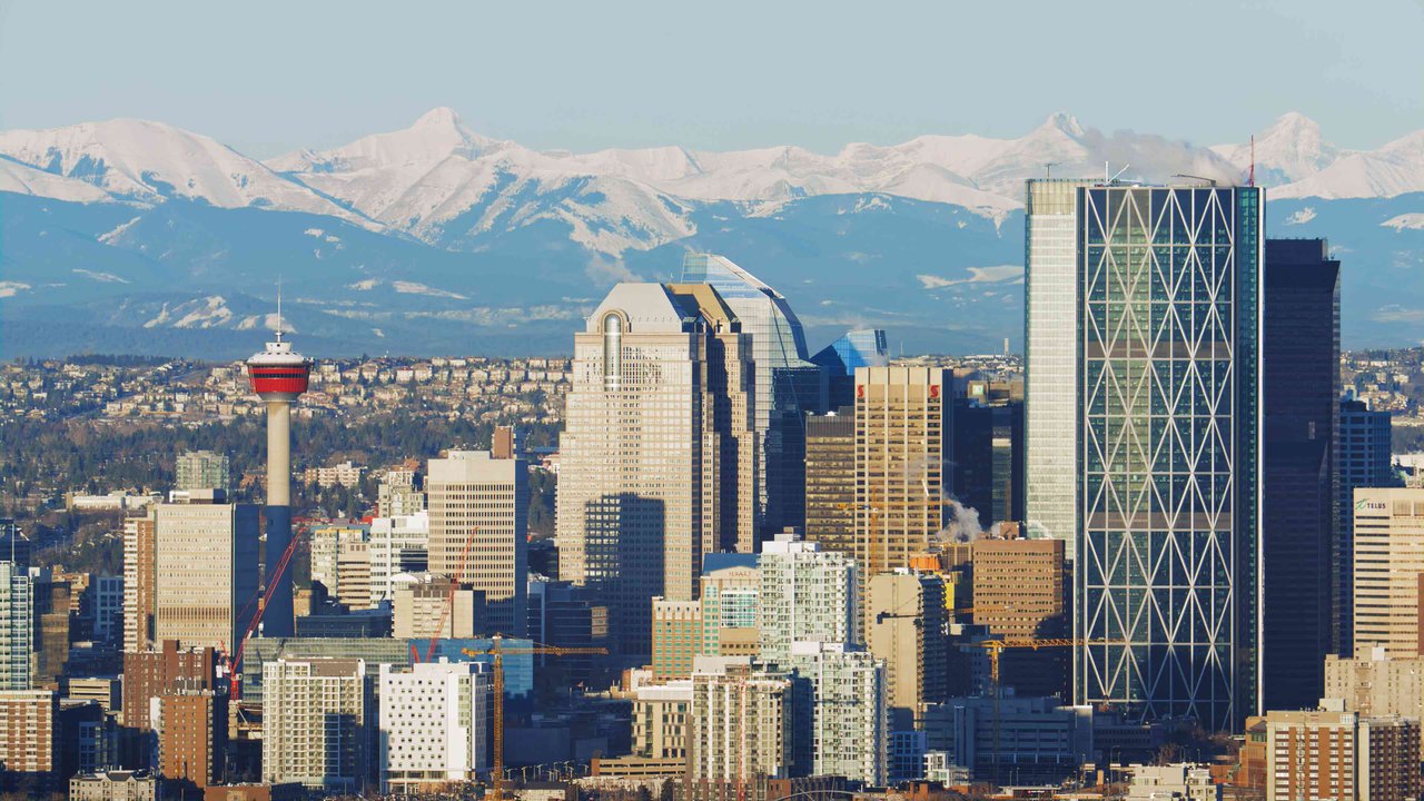 a view of the Calgary skyline witht the rockies in the background