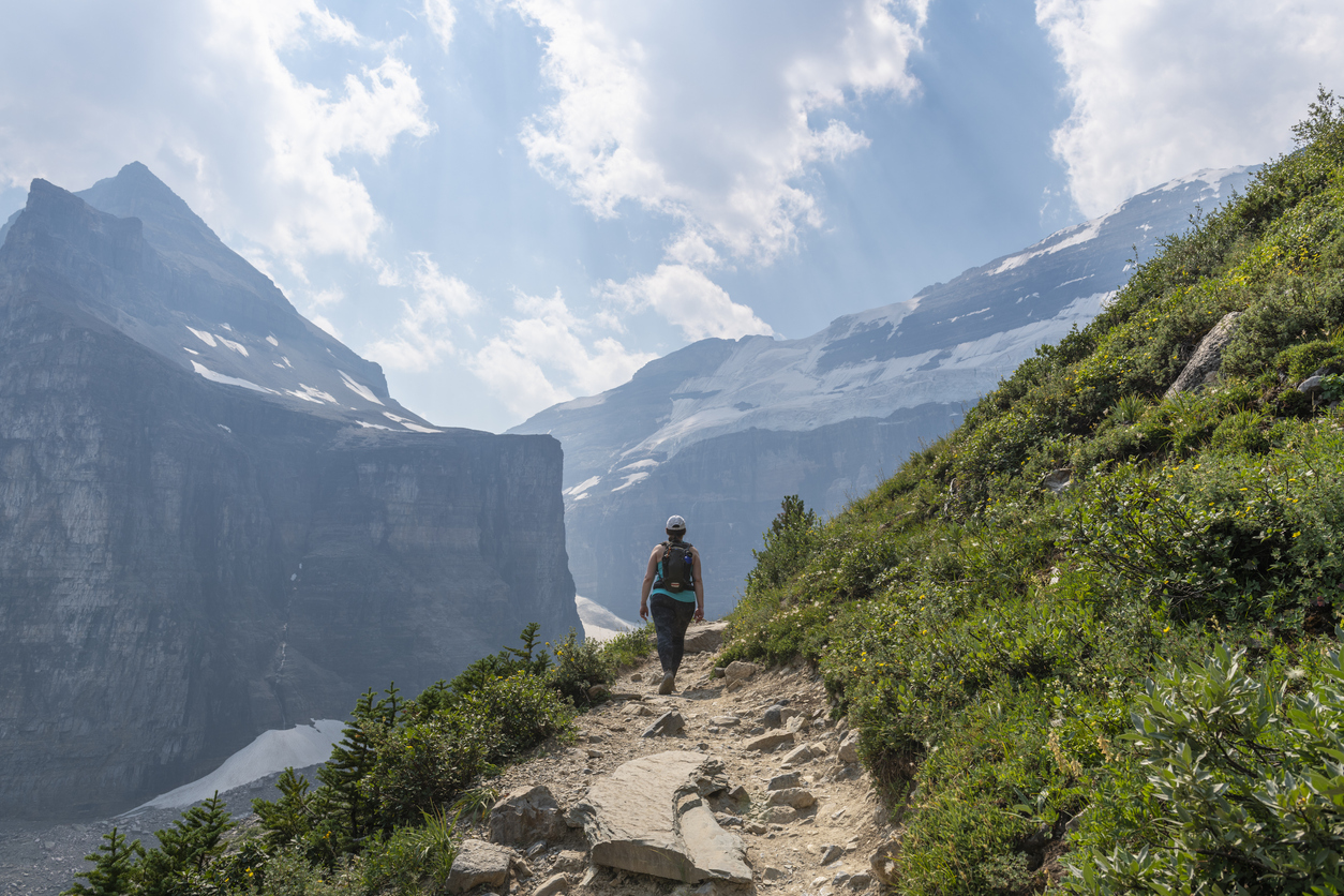 A woman walks along a trail in the Canadian Rocky Mountain Parks