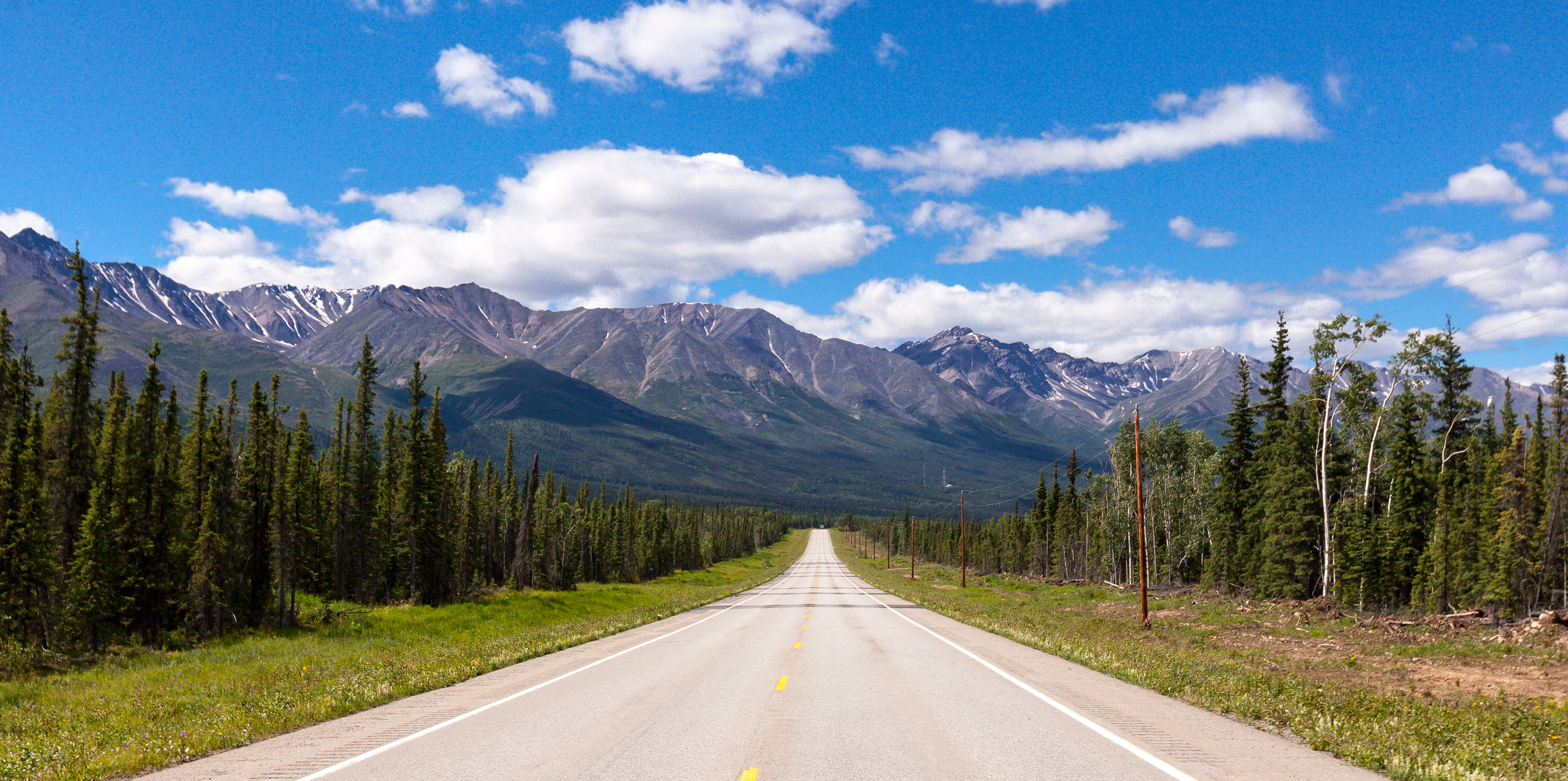 A highway with a range of mountains in the background