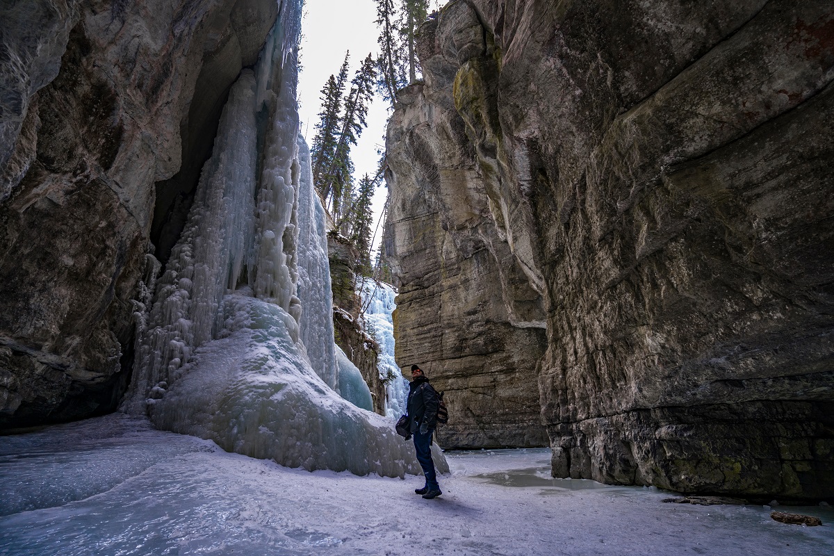 Person exploring Maligne Canyon in winter