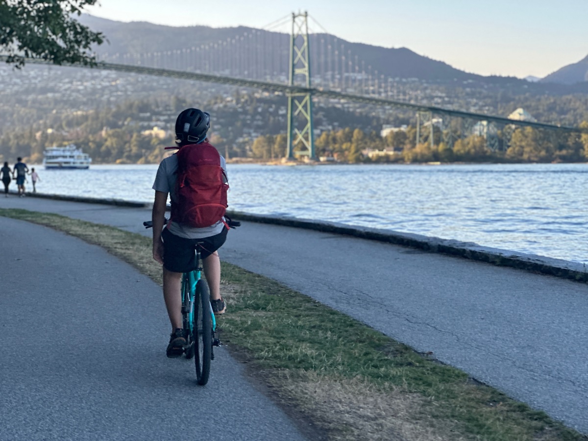 A man cycles the Stanley Park Seawall