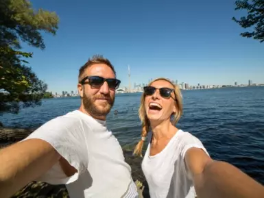 Couple of travelers taking selfie in Toronto