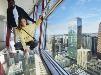 Couple on a glass floor at Calgary Tower