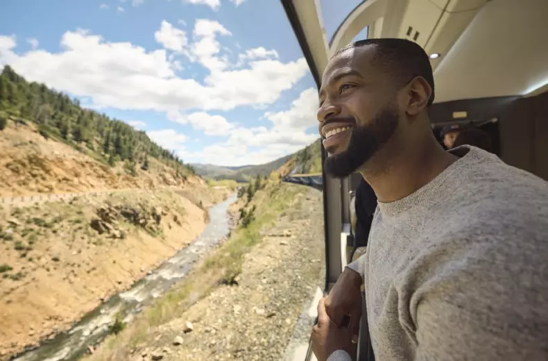 Man admiring view on Rocky Mountaineer train