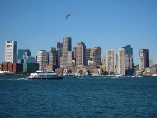 View of  Boston city skyline under a clear blue sky.