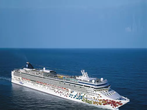 Norwegian Cruise Line sailing on the North America’s east coast under a clear sky.