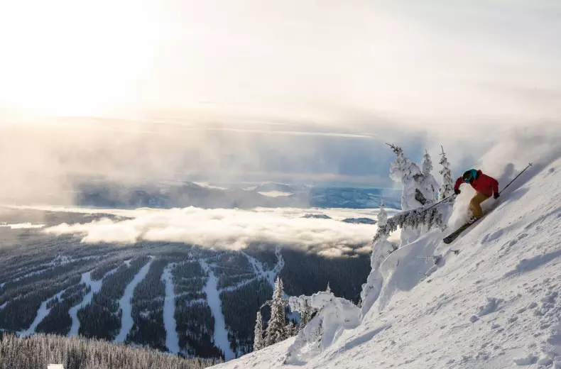 A skier on a ski trail in Sun Peak